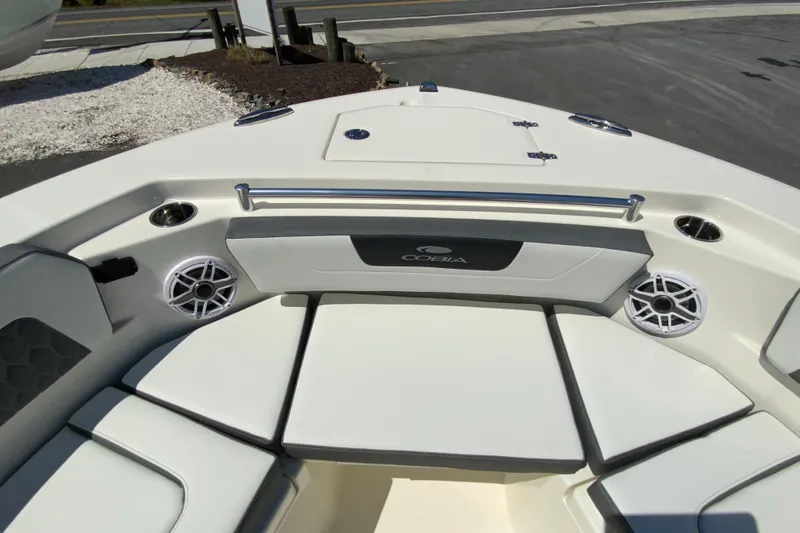 Slide: The Image of 2026 Cobia 245 Center Console boat interior with cushioned seating and speakers. - 31