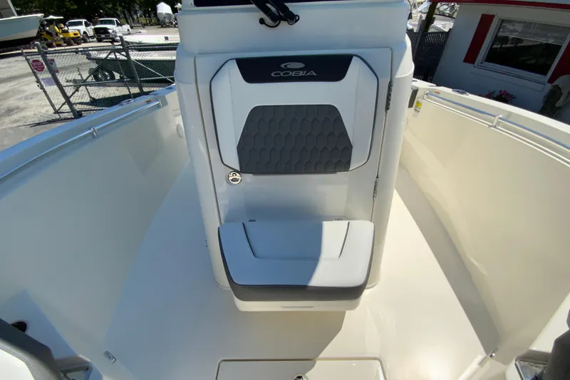 Slide: The Image of 2026 Cobia 245 Center Console boat interior with cushioned seating and sleek design. - 34