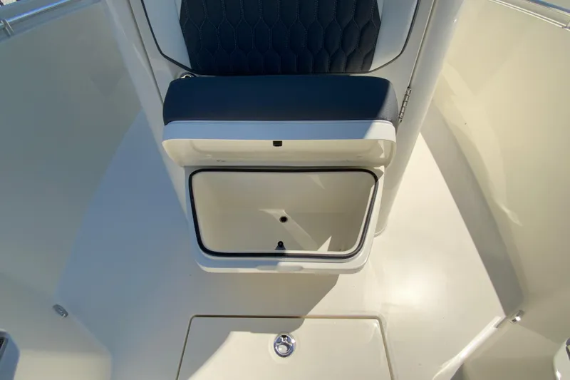 Slide: The Image of 2026 Cobia 245 Center Console boat seat with storage compartment open. - 35