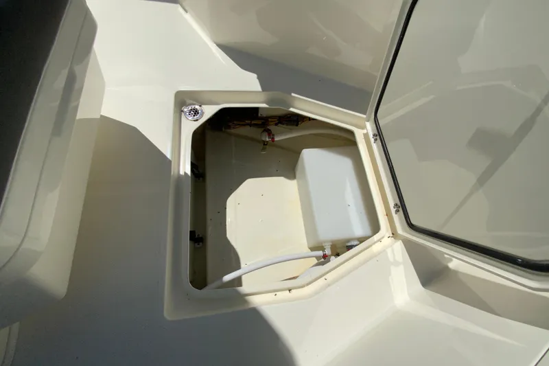 Slide: The Image of Open storage compartment on 2026 Cobia 245 Center Console boat. - 37