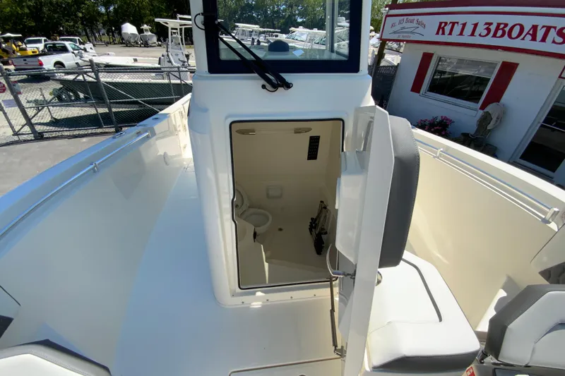 Slide: The Image of 2026 Cobia 245 Center Console boat with open cabin door, showcasing interior features. - 38