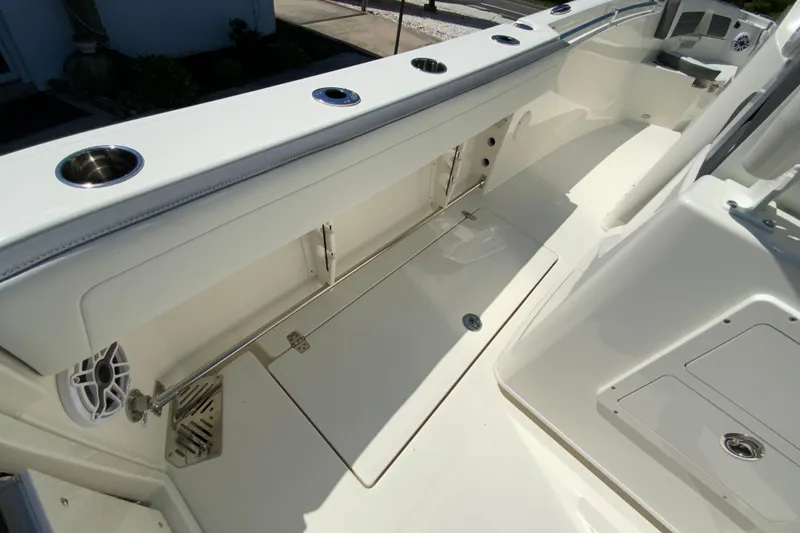 Slide: The Image of 2026 Cobia 245 Center Console boat interior with rod holders and storage compartments. - 42