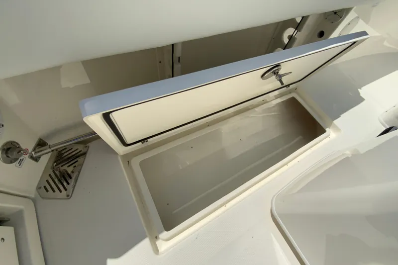Slide: The Image of Open storage compartment on 2026 Cobia 245 Center Console boat. - 43