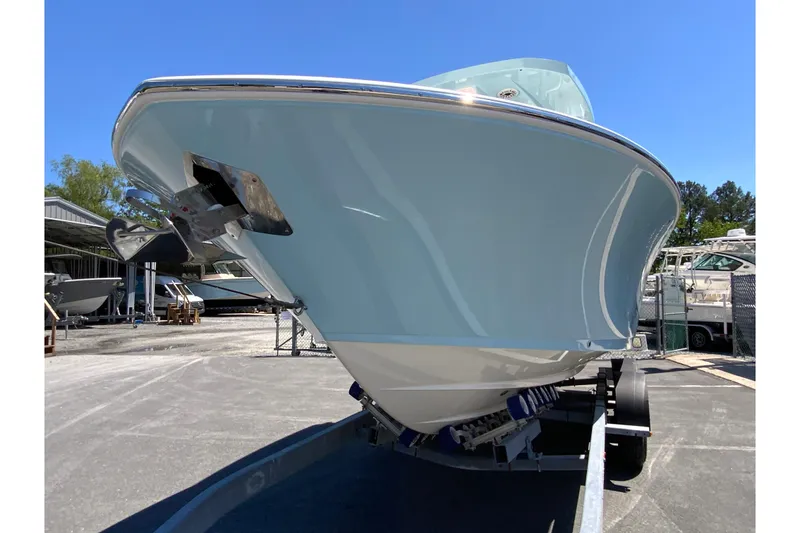 Slide: The Image of 2026 Cobia 245 Center Console boat on trailer, viewed from the front. - 5
