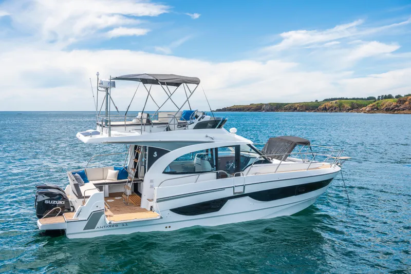 Slide: The Image of 2025 Beneteau Antares 11 Fly yacht on serene blue waters, showcasing luxury design. - 10