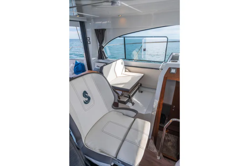 Slide: The Image of Interior of 2025 Beneteau Antares 11 Fly, featuring elegant seating and ocean view. - 16