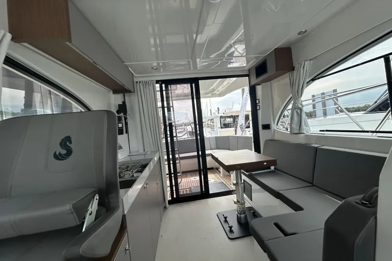 Slide: The Image of Interior of 2025 Beneteau Antares 11 Fly, featuring modern seating and sleek design. - 2
