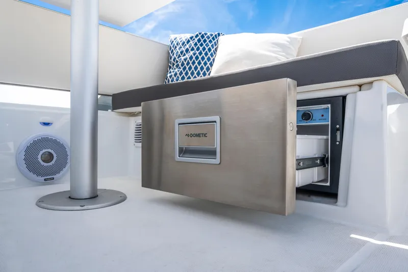 Slide: The Image of 2025 Beneteau Antares 11 Fly interior with Dometic fridge and cushioned seating. - 28