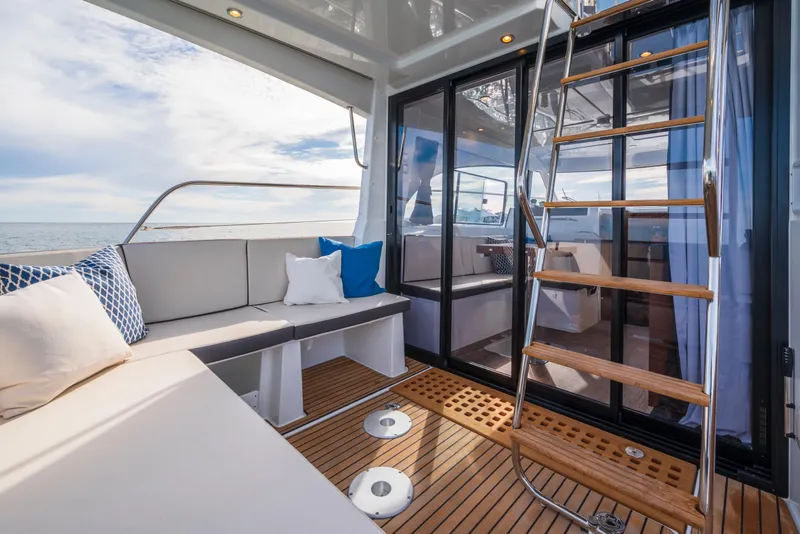 Slide: The Image of 2025 Beneteau Antares 11 Fly yacht interior with seating and wooden ladder. - 29
