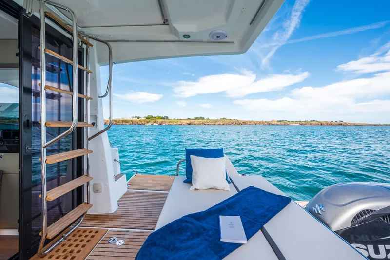 Slide: The Image of 2025 Beneteau Antares 11 Fly yacht interior with ocean view, featuring a cozy seating area. - 30