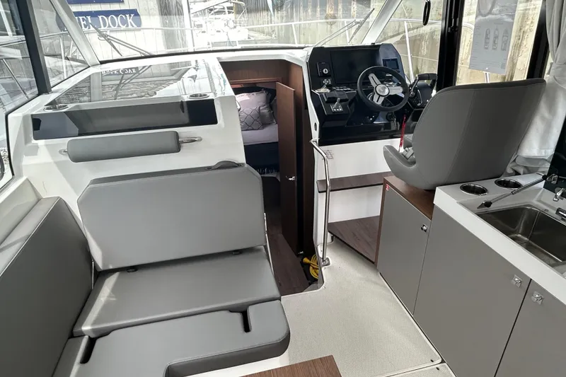 Slide: The Image of Interior of 2025 Beneteau Antares 11 Fly, featuring helm, seating, and kitchenette. - 5