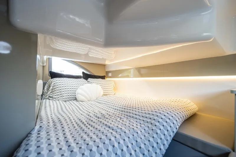 Slide: The Image of Luxurious cabin interior of 2027 Hanover 387 yacht with modern bedding and ambient lighting. - 2