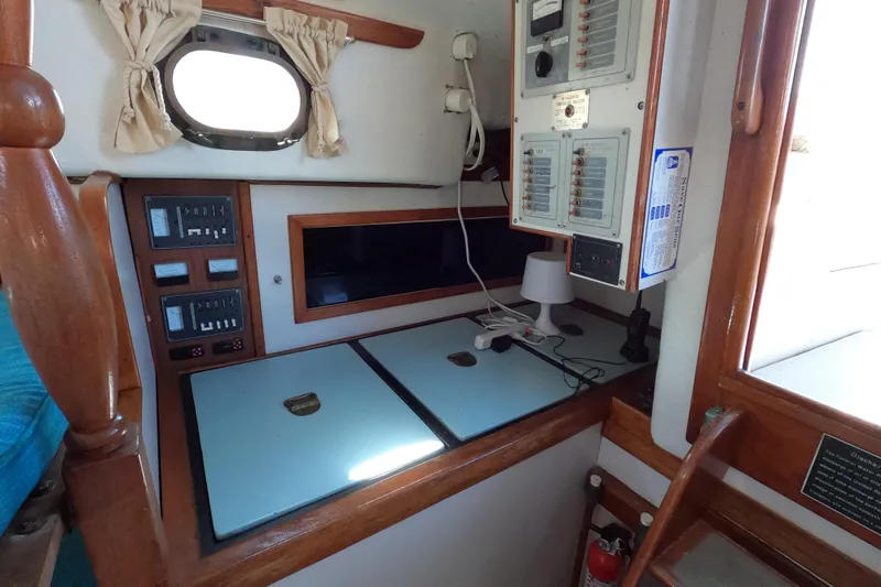 Slide: The Image of Interior of a 1978 CSY 44 sailboat featuring control panels and a small workspace. - 17