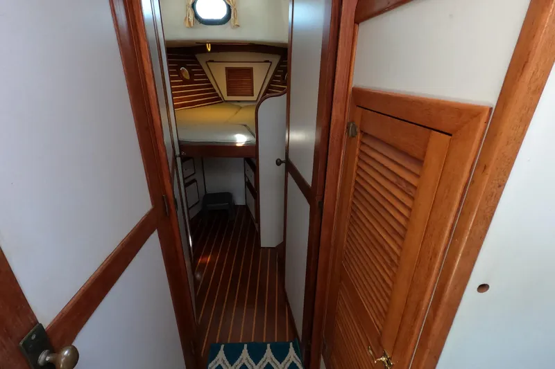 Slide: The Image of 1978 CSY 44 yacht interior with wooden paneling and cozy cabin space. - 18