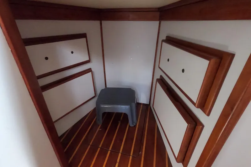 Slide: The Image of Wood-paneled interior of a 1978 CSY 44 sailboat with a small gray stool. - 21