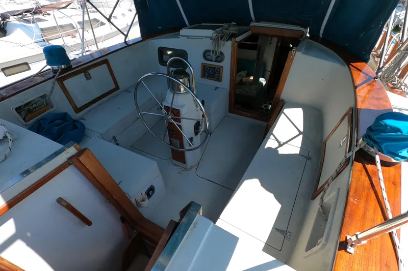 Slide: The Image of 1978 CSY 44 sailboat cockpit with steering wheel and wooden accents. - 28