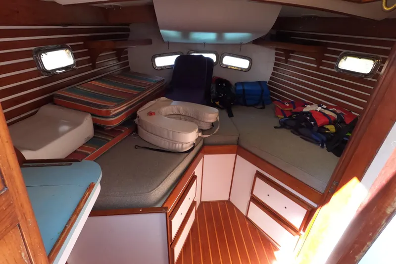 Slide: The Image of Interior cabin of a 1978 CSY 44 sailboat with striped cushions and life jackets. - 30