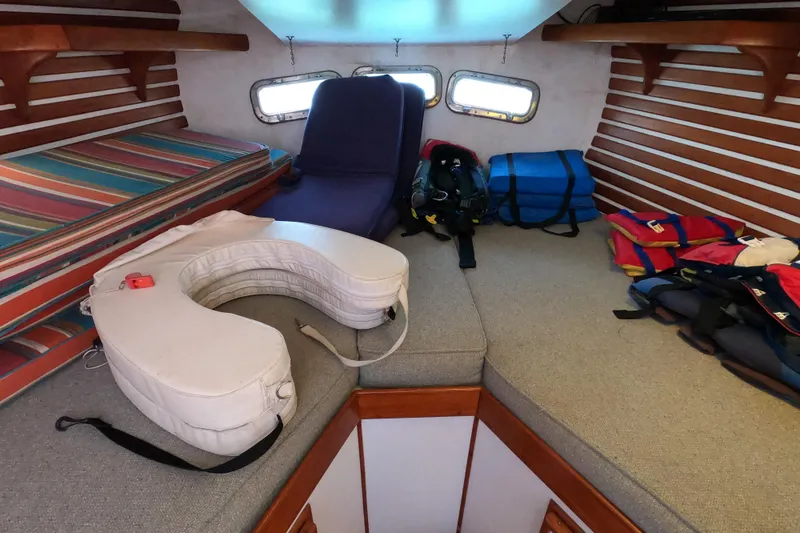 Slide: The Image of Interior of a 1978 CSY 44 sailboat cabin with cushions and life jackets. - 31