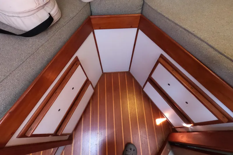 Slide: The Image of Interior of 1978 CSY 44 sailboat with wooden flooring and storage compartments. - 32