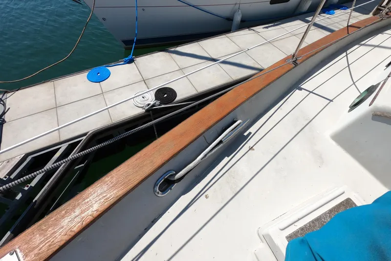 Slide: The Image of 1978 CSY 44 sailboat docked with ropes and cleats. - 37