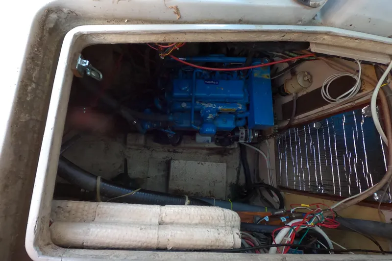 Slide: The Image of Engine compartment of a 1978 CSY 44 sailboat, featuring a blue marine engine. - 40