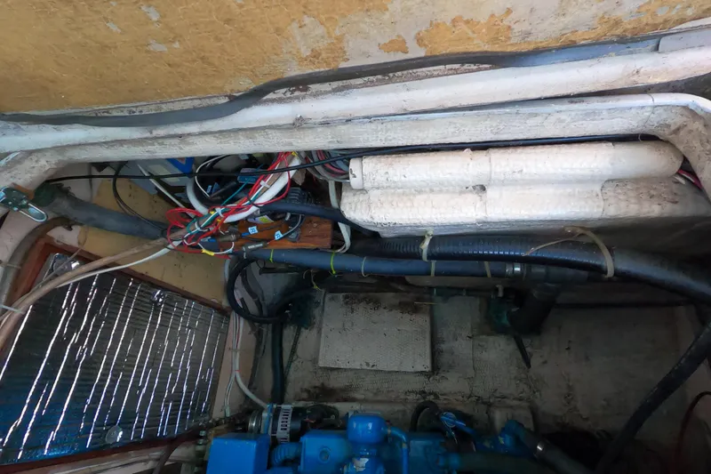 Slide: The Image of Engine compartment of a 1978 CSY 44 sailboat with visible wiring and insulation. - 41