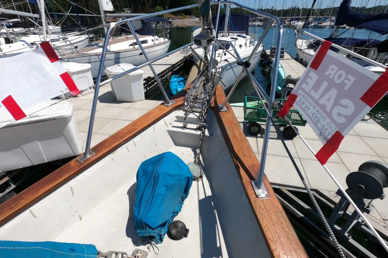 Slide: The Image of 1978 CSY 44 sailboat for sale at marina, featuring deck and railing view. - 7