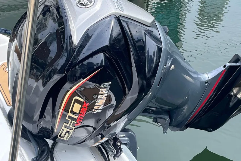 Slide: The Image of Yamaha SHO VMAX engine on a 2024 NauticStar 243 DC boat, docked by the water. - 3