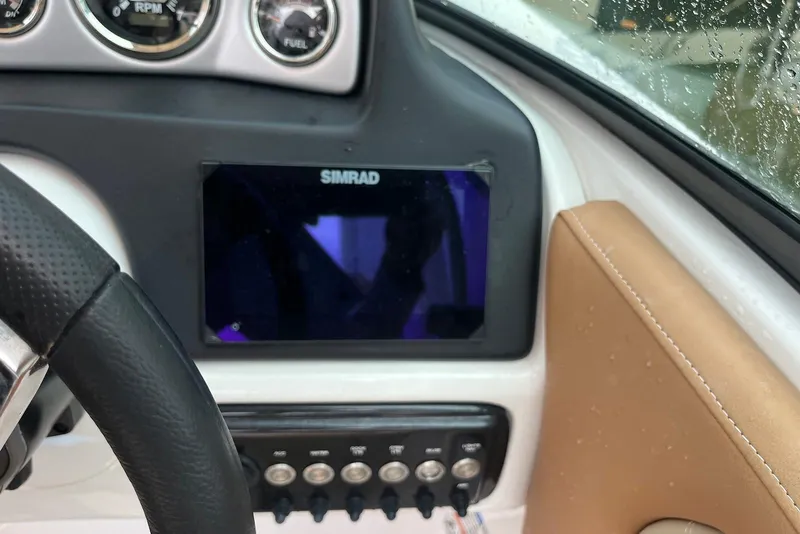 Slide: The Image of 2024 NauticStar 243 DC dashboard with Simrad display and control panel. - 7