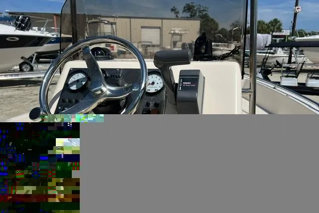 Slide: The Image of 2006 Key West 1720 Center Console boat dashboard with steering wheel and gauges. - 7