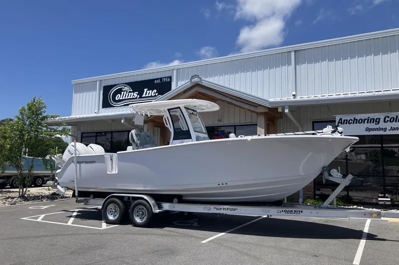 The Image of 2026 Sportsman Open 262 Center Console boat on trailer outside dealership. - 1