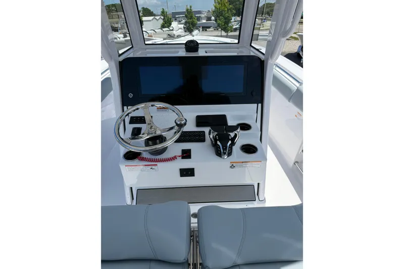 Slide: The Image of 2026 Sportsman Open 262 Center Console boat dashboard with steering wheel and digital displays. - 8