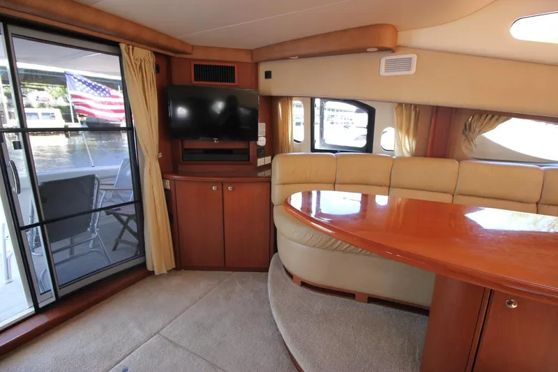 Slide: The Image of Interior of 2006 Silverton 38 Sport Bridge yacht with plush seating and TV. - 11