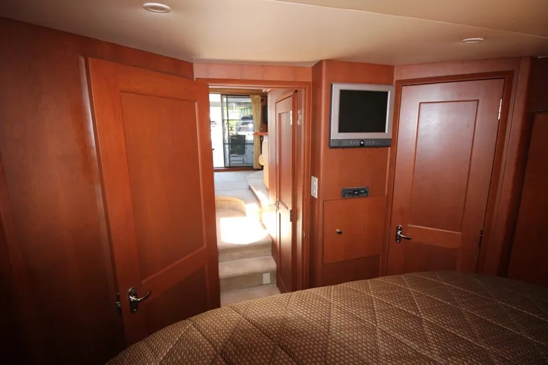 Slide: The Image of Interior of 2006 Silverton 38 Sport Bridge yacht with wood paneling and mounted TV. - 15