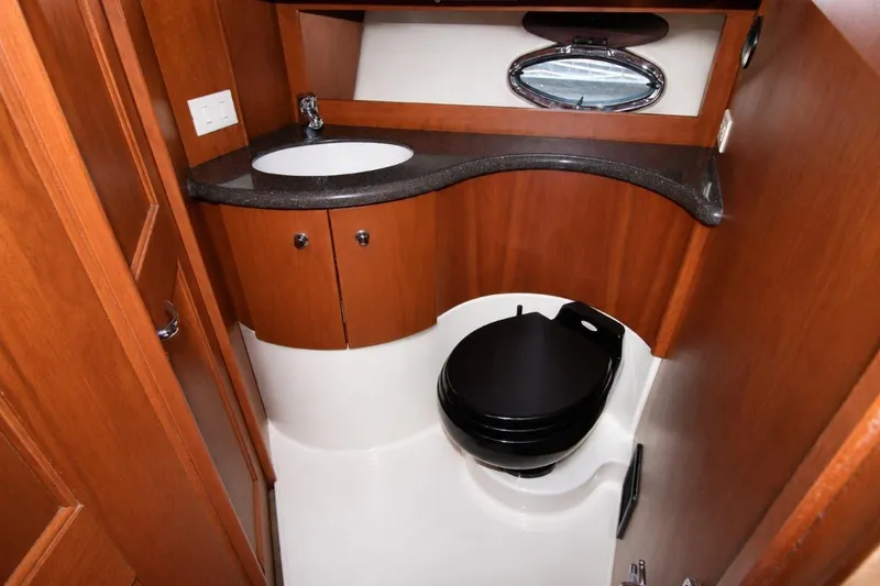Slide: The Image of Luxurious 2006 Silverton 38 Sport Bridge yacht bathroom with wood cabinetry and modern fixtures. - 17