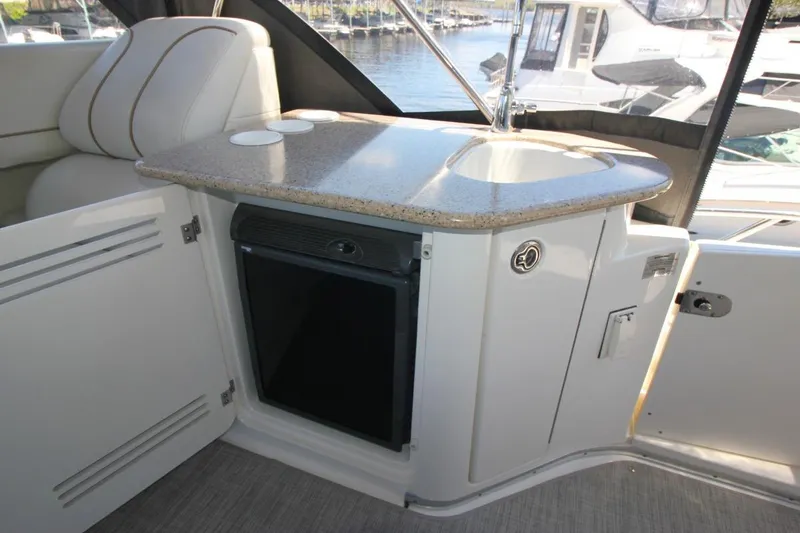 Slide: The Image of 2006 Silverton 38 Sport Bridge interior with sink and mini fridge. - 24