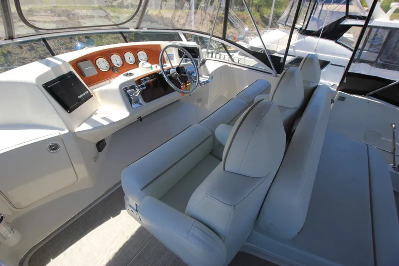 Slide: The Image of 2006 Silverton 38 Sport Bridge helm with modern controls and comfortable seating. - 25