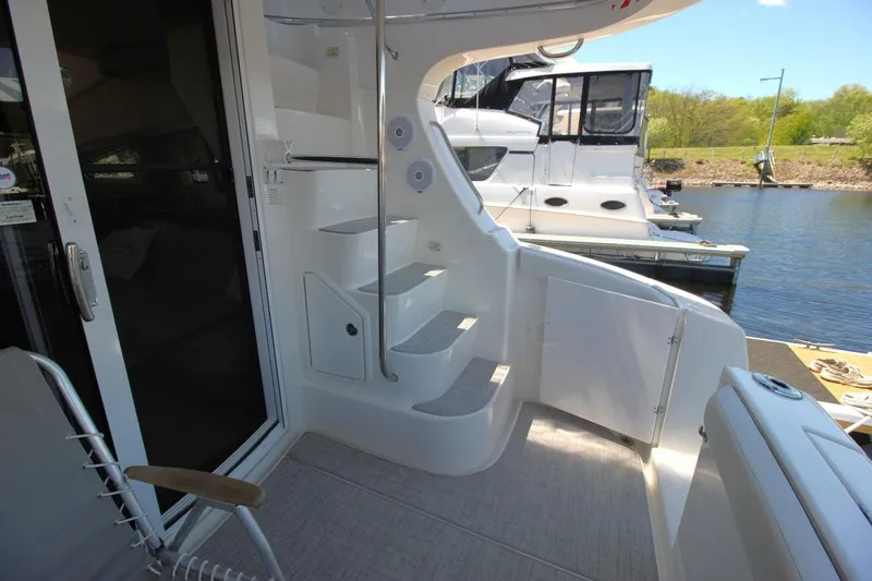 Slide: The Image of 2006 Silverton 38 Sport Bridge yacht interior with stairs and marina view. - 4