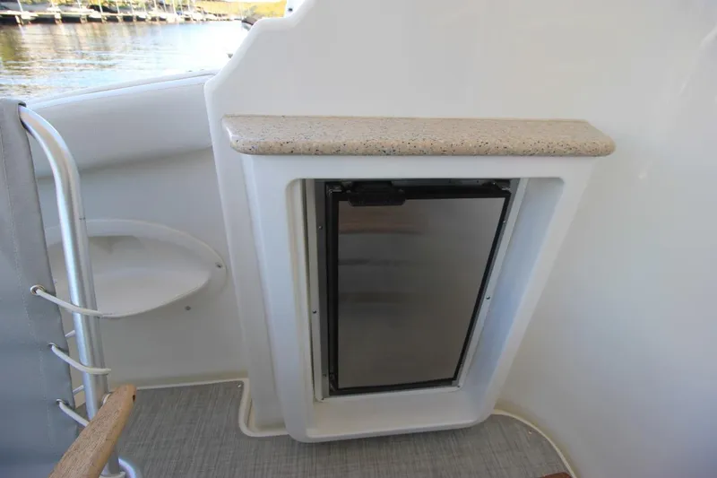 Slide: The Image of 2006 Silverton 38 Sport Bridge interior with compact fridge and countertop. - 6