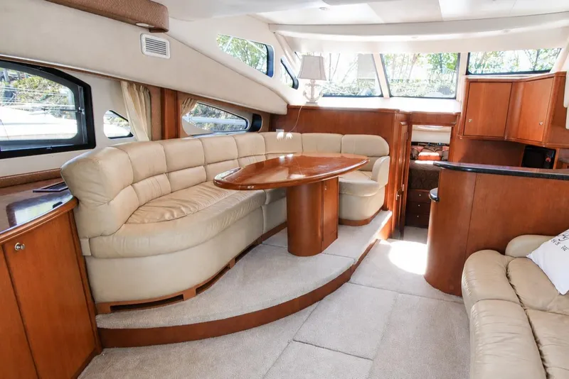 Slide: The Image of Luxurious interior of 2006 Silverton 38 Sport Bridge yacht with plush seating and wooden accents. - 7