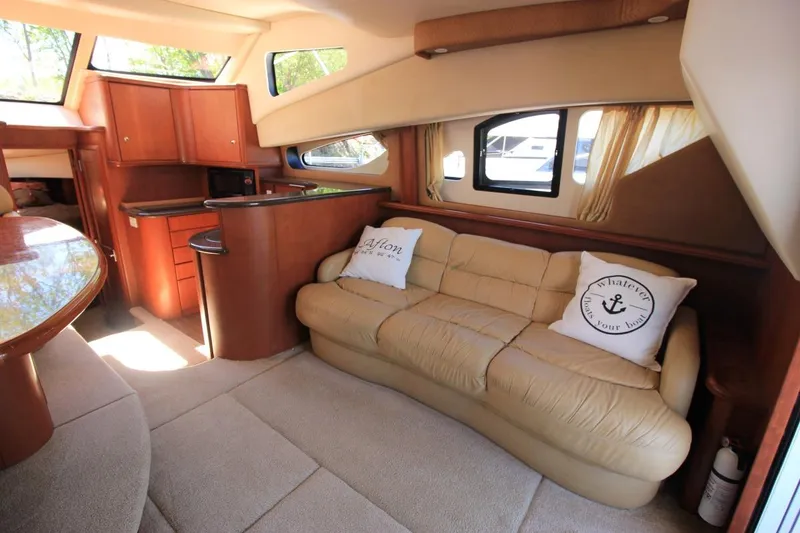 Slide: The Image of Luxurious interior of 2006 Silverton 38 Sport Bridge yacht with plush seating and elegant wood finishes. - 9
