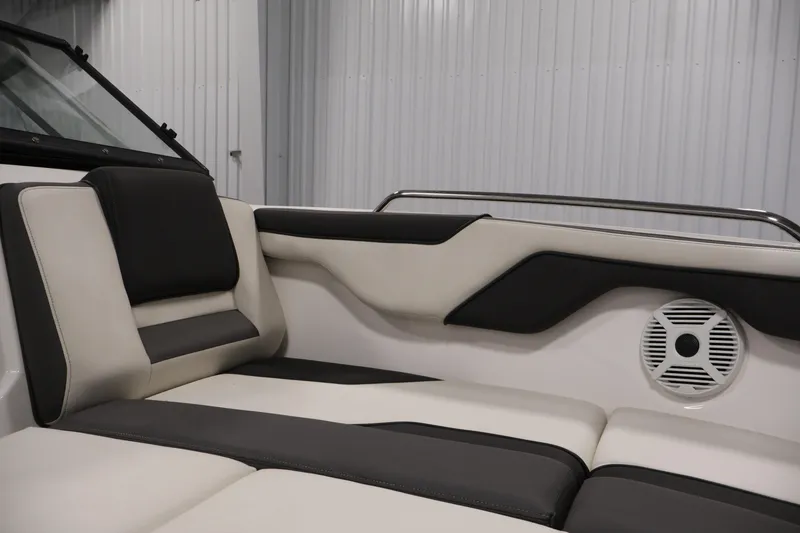 Slide: The Image of 2021 Yamaha AR210 boat interior with sleek black and white seating and speaker. - 14