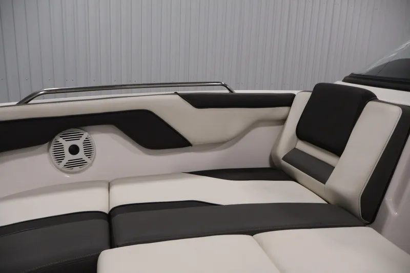 Slide: The Image of 2021 Yamaha AR210 boat interior with cushioned seating and speaker detail. - 16