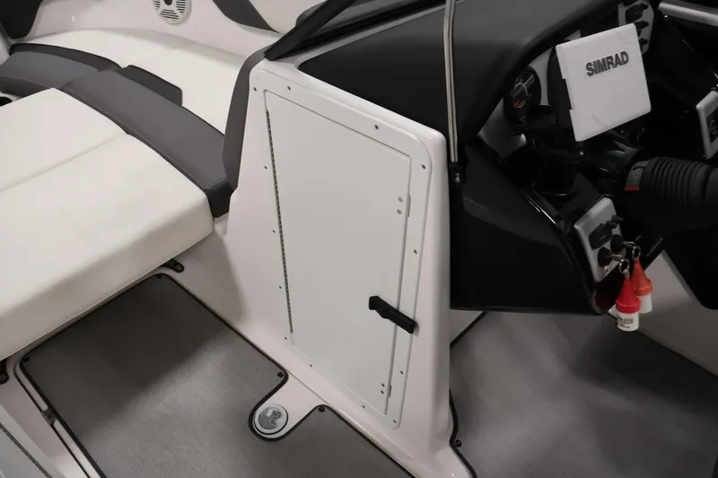 Slide: The Image of 2021 Yamaha AR210 boat interior with Simrad navigation system and seating area. - 18