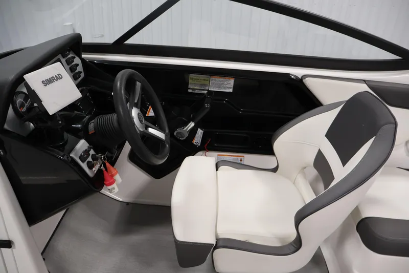 Slide: The Image of 2021 Yamaha AR210 boat cockpit with steering wheel and Simrad display. - 19