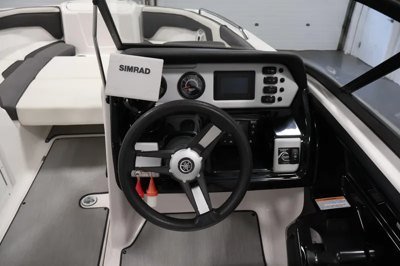 Slide: The Image of 2021 Yamaha Boats AR210 dashboard with steering wheel and Simrad navigation system. - 20