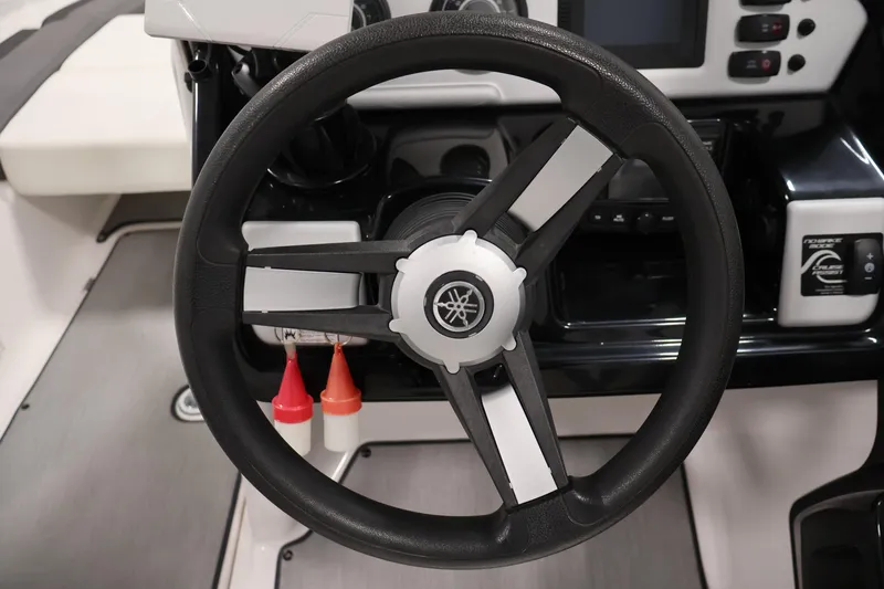 Slide: The Image of Steering wheel of a 2021 Yamaha Boats AR210, featuring a sleek, modern dashboard design. - 21