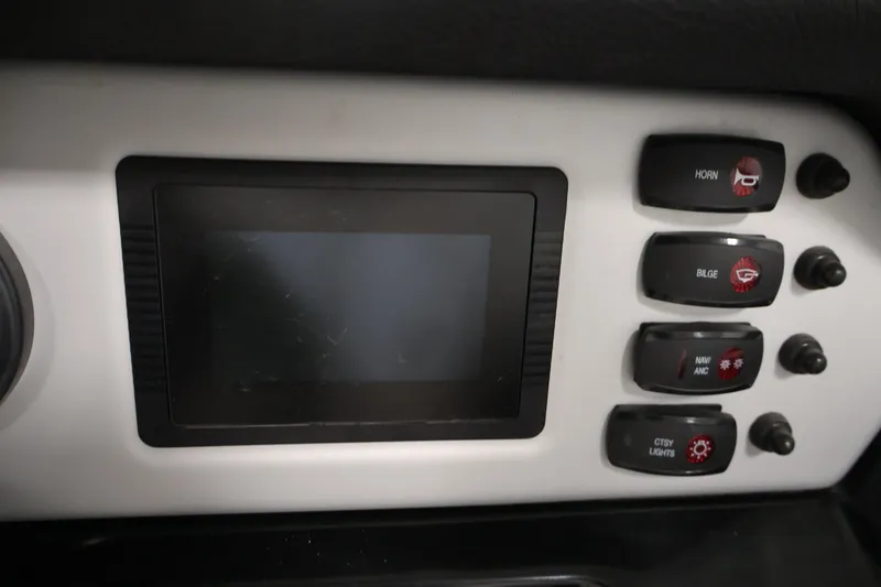 Slide: The Image of Control panel of 2021 Yamaha AR210 boat with screen and switches for horn, bilge, and lights. - 25
