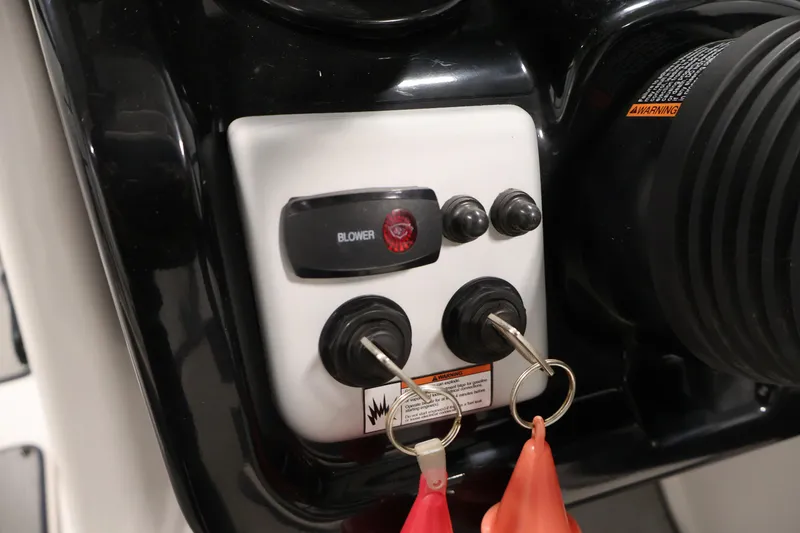 Slide: The Image of Control panel of 2021 Yamaha AR210 boat with ignition keys and blower switch. - 28