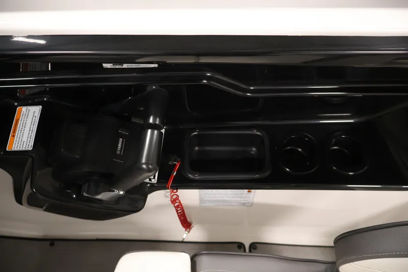 Slide: The Image of 2021 Yamaha AR210 boat cockpit with control panel and cup holders. - 29
